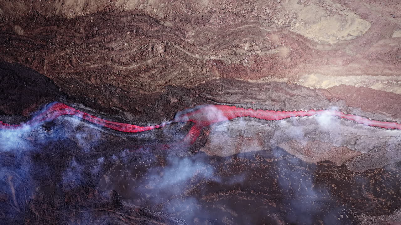Lava flows from Mount Etna, Sicily, casting red hues and smoke trails