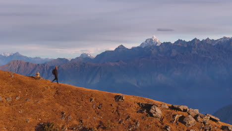 a male tourist treks in ridge drone shot of nepal everest mountain range at pikeypeak landscape 4k