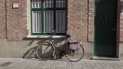 bicycle parked outside a typical old house in Bruges Belgium