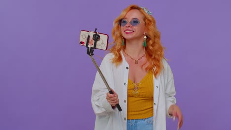blogger viajera con gafas de sol, tomando selfies en el teléfono móvil, comunicándose por video llamada en línea