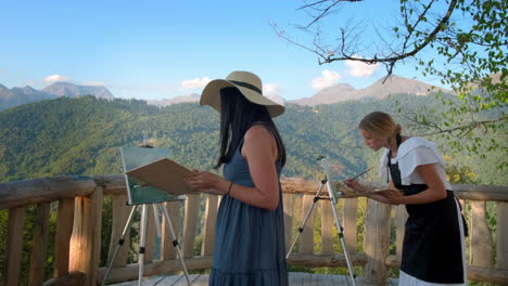 women artists painting in the mountains