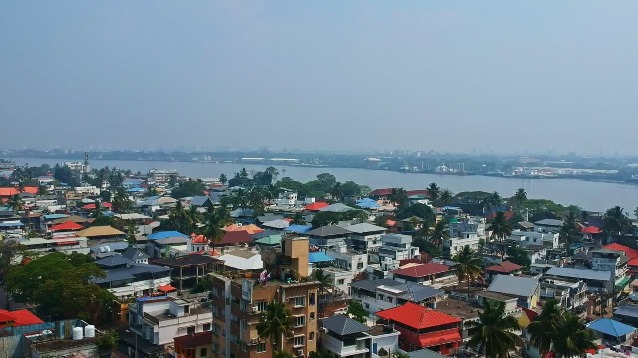 Aerial view of Kochi city from Fort Kochi , A lake flowing through the middle of Kochi city , Aerial view of crowded city houses