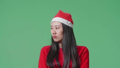 woman in santa hat looking disappointed