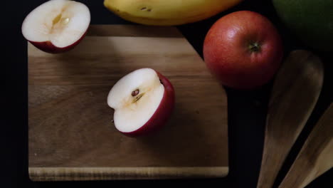 Fresh-slices-of-red-apple-falling-in-two