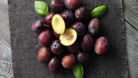 served ripe plums on napkin