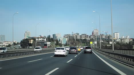 cars driving on a highway bridge over a city