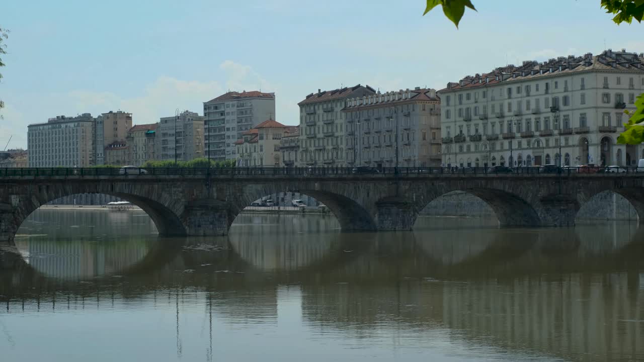 Panning Wide Shot of Italian Bridge Behind Leaves with Turin City Backdrop