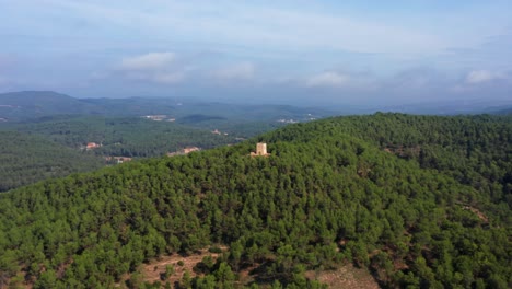 Aerial-point-of-interest-shot-around-a-medieval-stone-tower-in-the-top-of-a-mountain-in-Catalonia