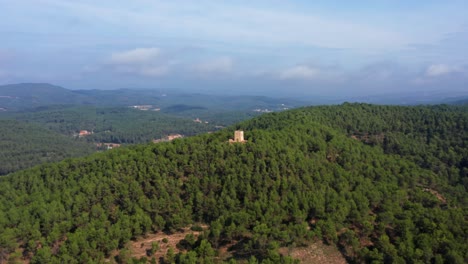 aerial point of interest shot around a medieval stone tower in the top of a mountain in catalonia