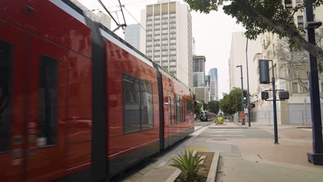 slow motion of trains passing by in urban downtown san diego california