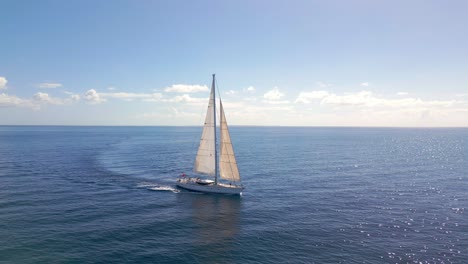 drone tracking shot of oyster luxury sailing yacht cruising in open ocean