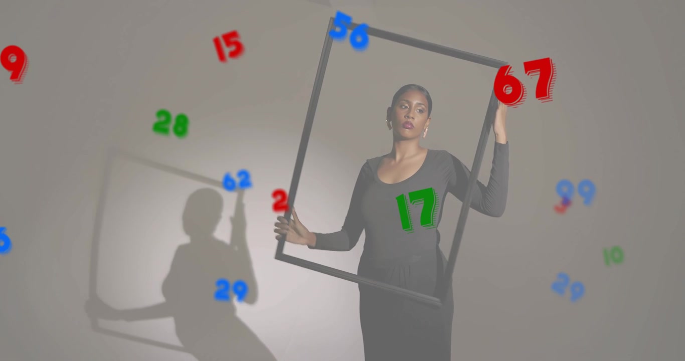 Model rotating black frame in studio activating floating multicolor numbers showing graphic design
