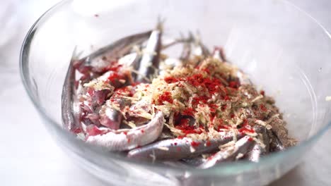 add the spices to the bowl of sardines