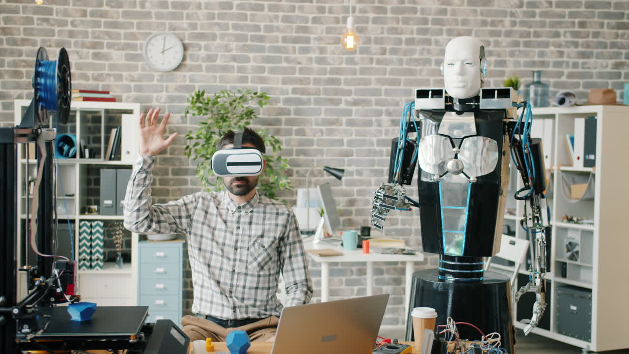 Man in VR interacts with a robot in a modern office workspace