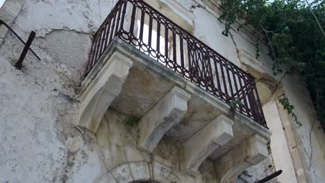 damaged building with sunlit balcony