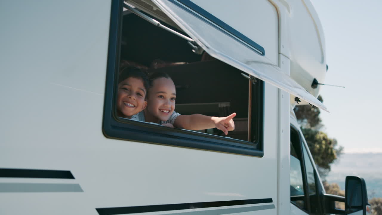 Two Happy Children Smiling and Pointing from Camper Van Window