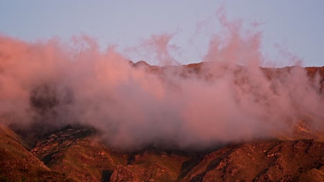 Dramatic-and-epic-view-of-a-mountain-timelapse-with-orange-clouds-at-sunset-in-Merlo,-San-Luis-in-Argentina