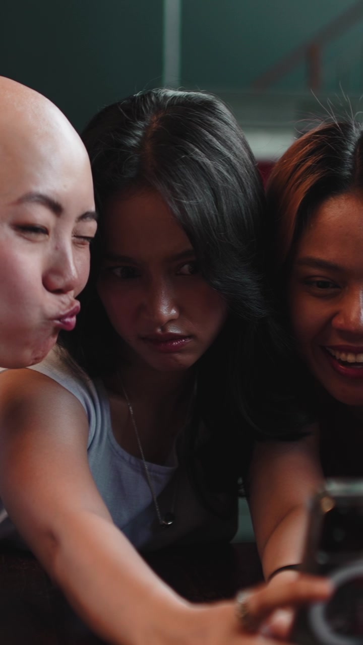 Three Diverse Young Women Taking Selfies Together