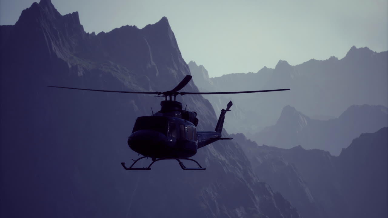 Helicopter flying over majestic mountains during twilight hours