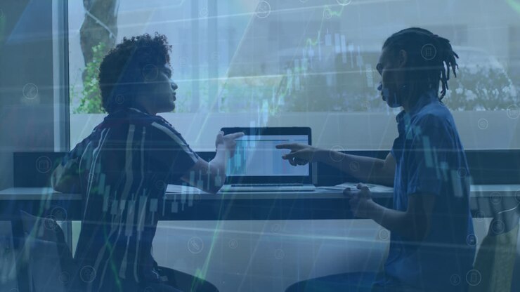 Animation of financial data processing against two diverse man discussing over a laptop at office