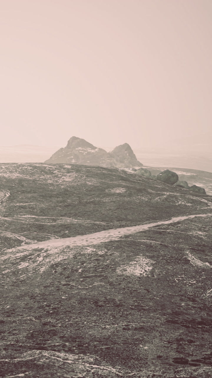 Mountain landscape with rocky peaks and winding paths under cloudy sky