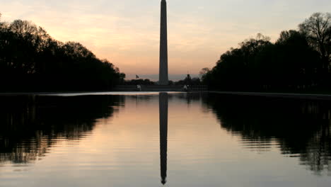 the washington monument is silhouetted against a colorful sky in washington dc 3