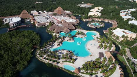 luxury hotel resort at mexican coastline of caribbean sea, pools and buildings, drone aerial view