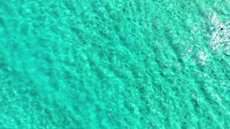 ocean waves moving towards the rocky shore