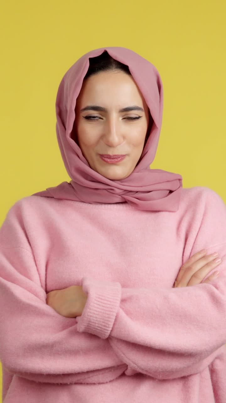 Woman in hijab with crossed arms