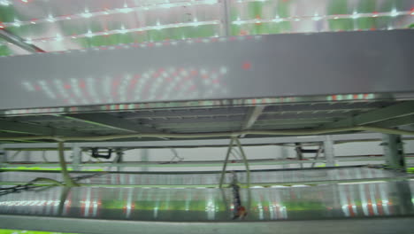 scientists and farmers work together in a team to create clean plants in an artificial environment using modern technology laptops and tablets.