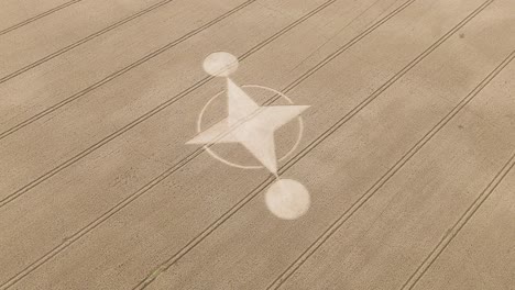 mysterious preston candover crop circle in brown farm field, aerial view