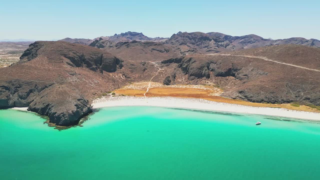 Aerial shot of Tecolote Beach in La Paz, showing turquoise waters and rocky hills