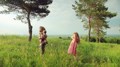 Full-length-view-of-a-caucasian-little-girl-smiling-and-posing-while-her-brother-taking-picture-in-the-park-on-a-sunny-day