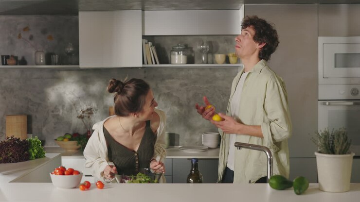 A Couple Prepares a Healthy Salad in a Modern Kitchen