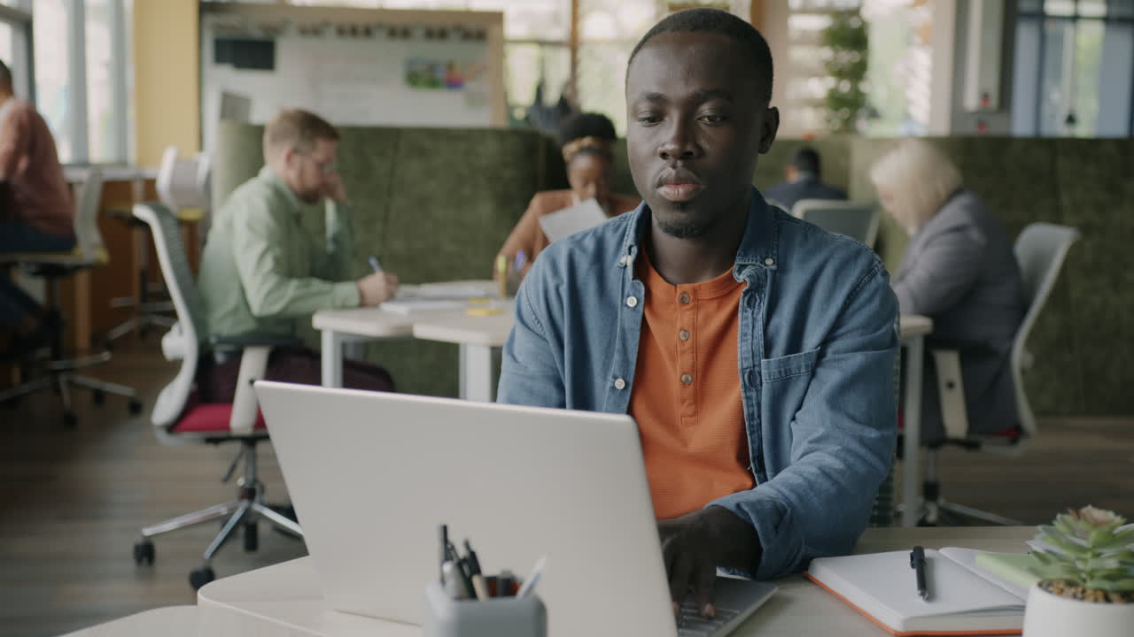 Man working on laptop in modern office