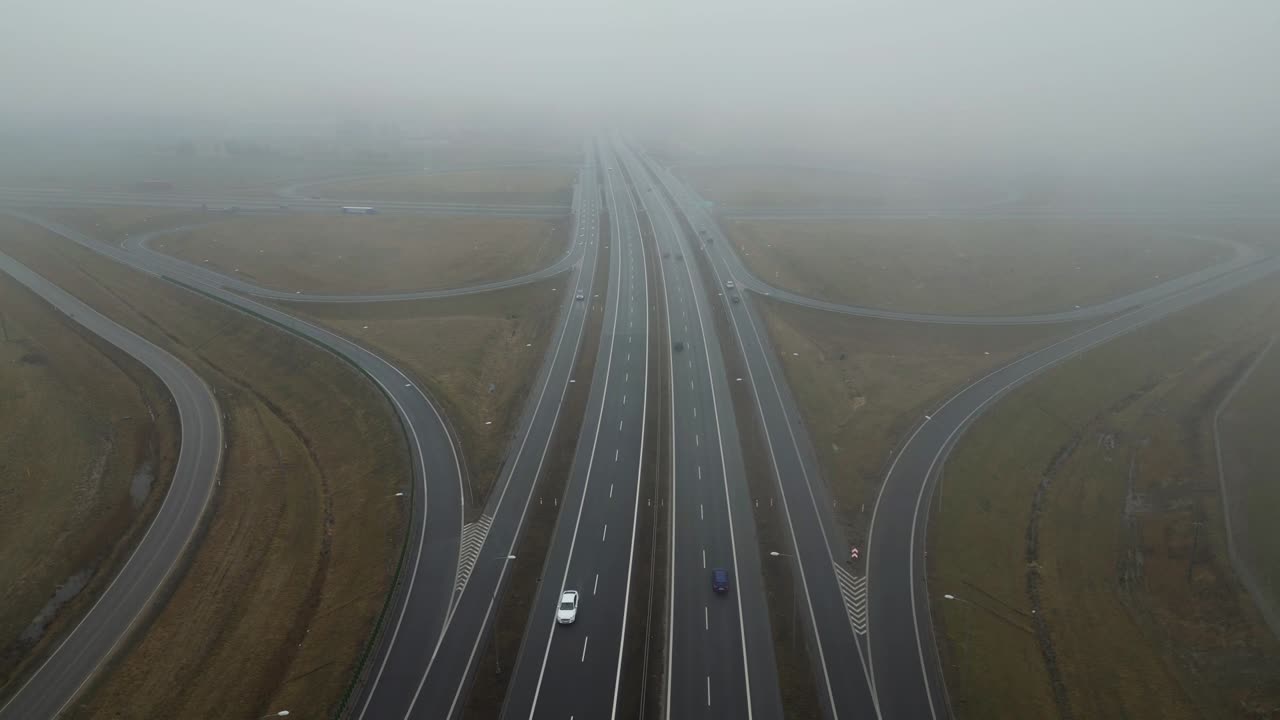 Road Interchange in Autumn Fog with Traffic Flow