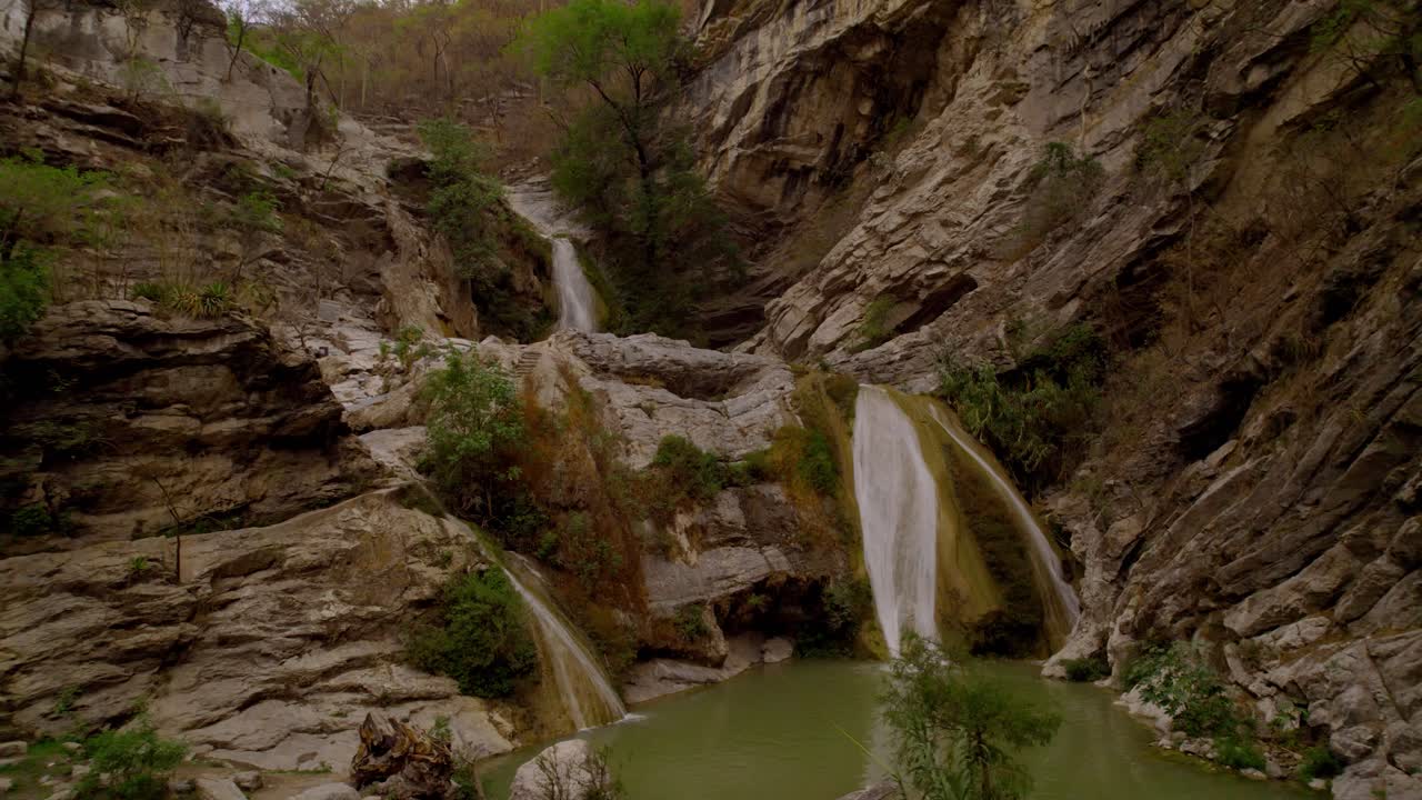 Drone video of a waterfall flowing from the ravine in the desert of M&eacute;xico