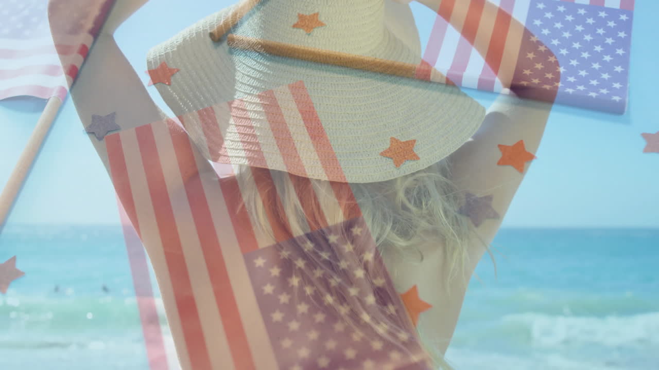 Wearing sun hat, woman at beach with animation of American flag overlay