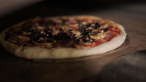 man cooking pizza in the kitchen of restaurant