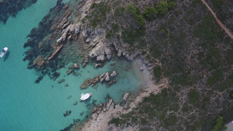 Twisting-FPV-view-of-small-rocky-hidden-beach-in-Spain