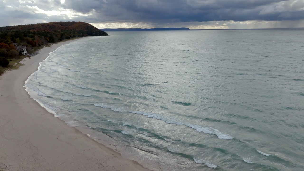 Lake Michigan shoreline in Leland, Michigan on a fall day with stable drone video.