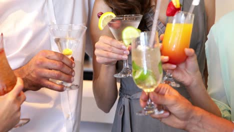 group of friends toasting with cocktails