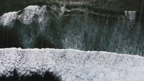 aerial-close-up-top-down-view-of-ocean-big-waves-crashing-on-the-barrier-Reef-clear-pristine-water,-minimalist-footage-concept