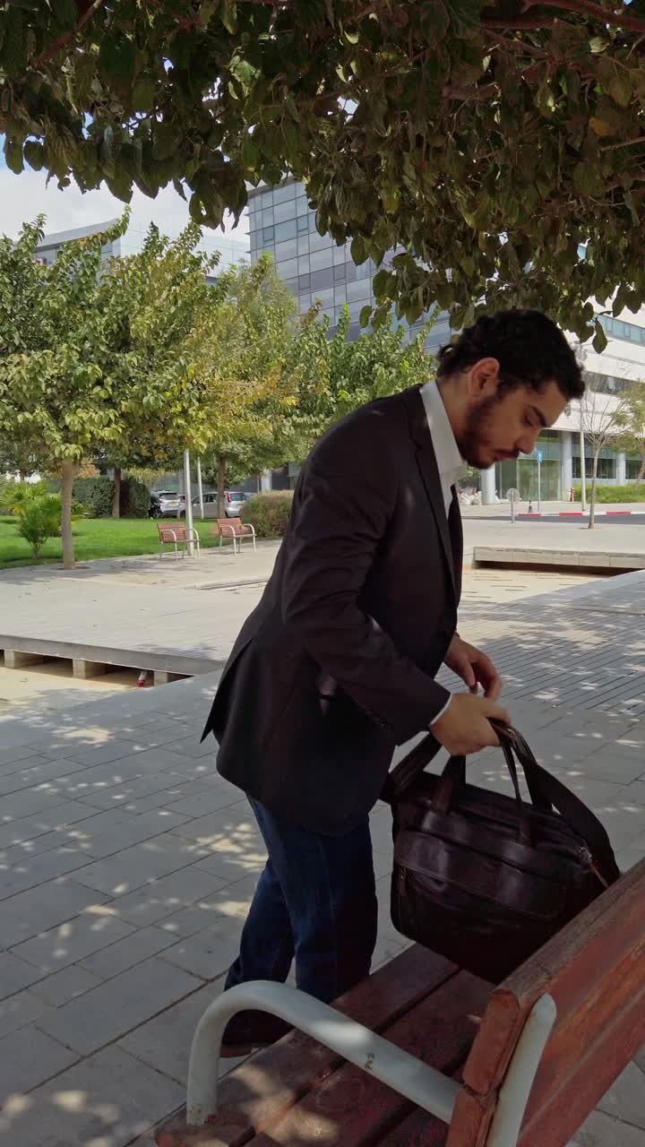 Business Lifestyle: Carrying Briefcase Through City Park