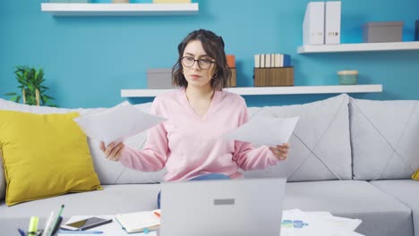 Young-woman-working-from-home-is-indecisive-and-stressed.