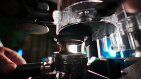 closeup-of-a-coffee-grinder-as-a-person-pours-a-portion-of-ground-coffee-into-a-spoon-to-prepare-a-cup-of-coffee