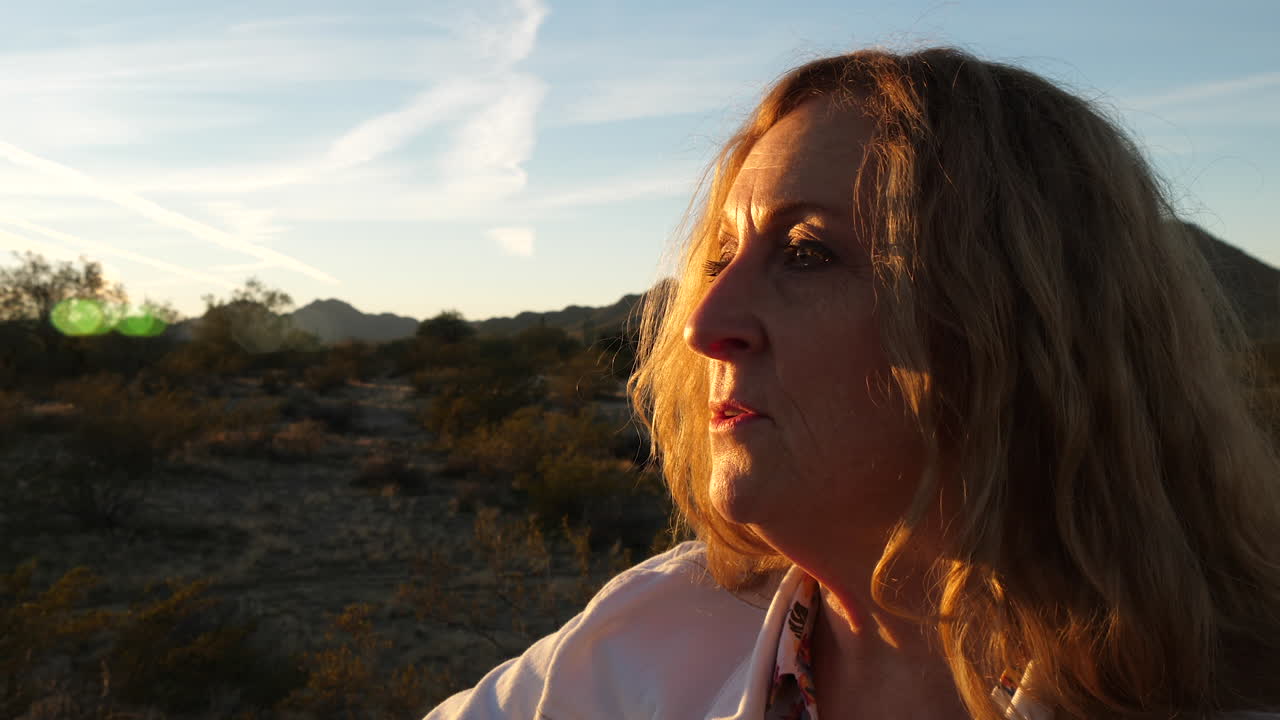 Woman Contemplating at Sunset in the Desert