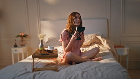 happy writer holding book in cozy bedroom. beautiful girl resting home hug diary