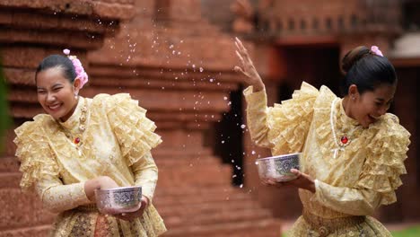 young beautiful women enjoy to splashing water on songkran festival