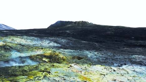 yellow geothermal sulfur deposit with steam rising from vent, fagradalsfjall valley